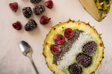 Green smoothie in pineapple