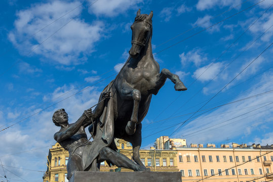 RUSSIA, SAINT PETERSBURG - AUGUST 18, 2017: Famous sculpture "A young man taking a horse by the bridle" on Anichkov Bridge across the Fontanka River, designed by the Russian sculptor Baron Peter Klodt