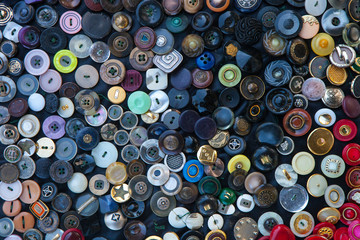 Textured background of buttons of different color and size