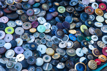 Textured background of buttons of different color and size