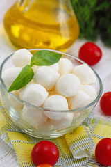 Mozzarella, cherry tomatoes and fresh greens - ingredients for caprese salad