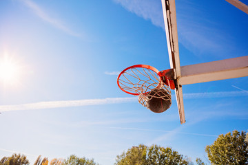 basketball close up, basketball bal in hoop at sunny day