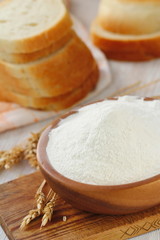 Fototapeta na wymiar Flour in bowl with grain ears