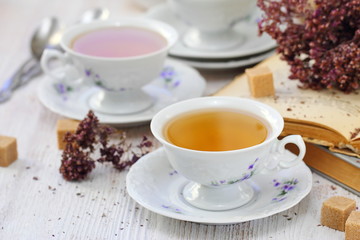 Cup of herbal tea and flowers