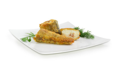 Slices of the fried fish and greens on square dish