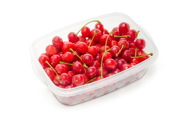 Washed red cherries in plastic container