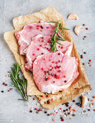Fresh raw pork chops with spices and herbs