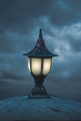 street lamps and lights against blue cloudly evening sky