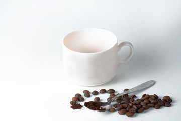 Coffee cup and beans on old kitchen table.