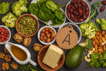 Healthy food nutrition dieting concept. Assortment of high vitamin A sources. Carrots, nuts,...