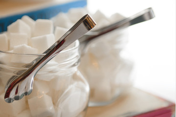 Sugar refined in glass transparent jars. Spices for tea and coffee. 