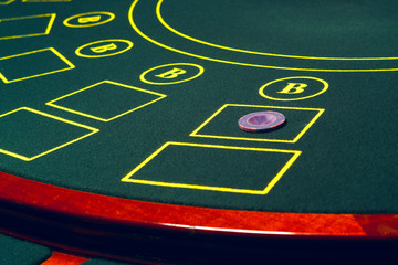 Casino pocker table with chips and cards. Winning combination. Hand of Croupier behind gambling table.