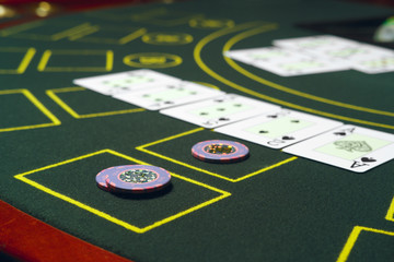 Casino black jack table with chips and cards. Winning combination.