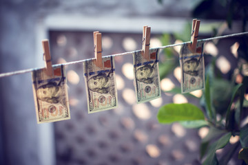 US dollar banknotes hanging on rope for money laundering conept