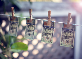 US dollar banknotes hanging on rope for money laundering conept