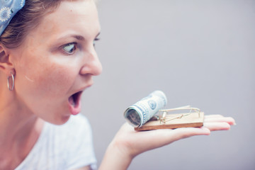 woman take dollar from mous trap business credit trap concept