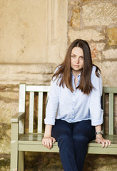 young woman sitting on a bench