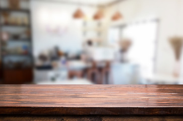 Selected focus empty brown wooden table and Coffee shop or restaurant blur background with bokeh image. for your photomontage or product display.