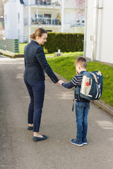 Young boy is afraid to go to school. Mom persuades him