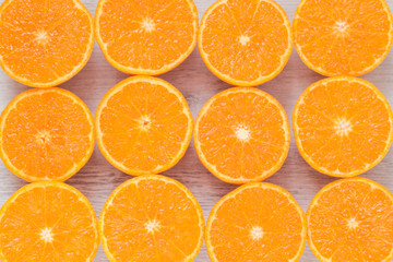 Juicy mandarines cut in half on a wooden background