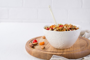 Bowl with homemade granola on white background for healthy breakfast . Healthy snak.