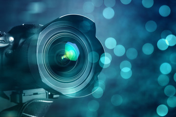Fototapeta na wymiar Closeup of a digital camera and shiny bokeh background.
