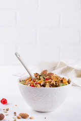 Bowl with homemade granola on white background for healthy breakfast . Healthy snak.