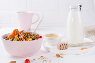 Bowl with homemade granola on white background for healthy breakfast . Healthy snak.