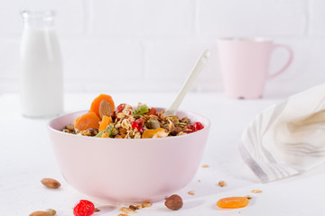 Bowl with homemade granola on white background for healthy breakfast . Healthy snak.