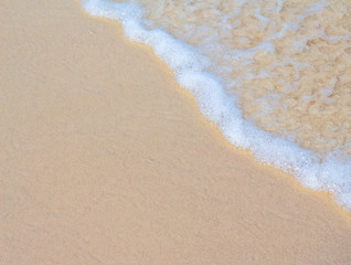 Fototapeta na wymiar Sea wave and white sand beach photo background. Sunny beach sand with sea wave.