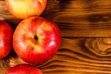 Ripe red apples on the wooden table. Top view