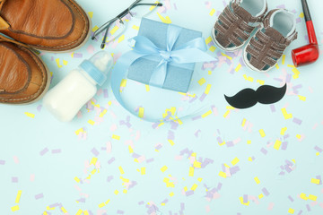 Table top view Happy Fathers day holiday background concept.Flat lay decoration gift box for dad with accessories objects sign of season on modern rustic blue paper at home office desk.pastel tone.