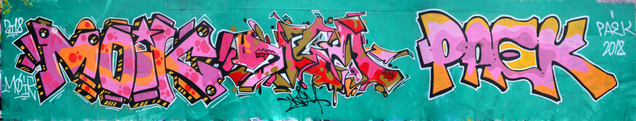 Fragment of a beautiful graffiti pattern in pink and green with a black outline. Street art background image