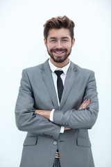 Confident bearded businessman standing with arms crossed