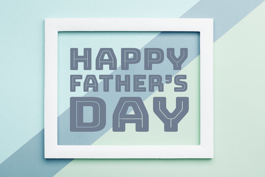 Happy Father's day Pastel Candy Colours Background. Flat lay minimalism Father day greeting card with picture frame.