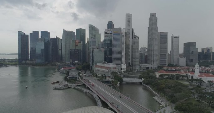 4k aerial footage of Singapore skyscrapers with city skyline during cloudy summer day