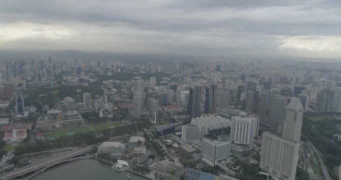 4k aerial footage of Singapore skyscrapers with city skyline during cloudy summer day