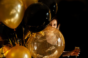 Happy Girl with Balloons and Champagne. Great Copy Space for Golden Text