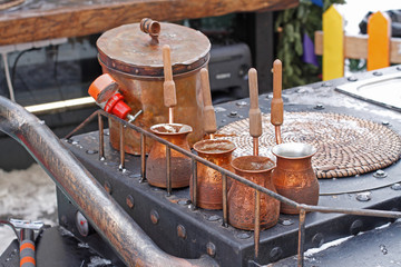 Turkish coffee pots standing on a metal gas stove