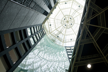 Directly below view of tall office building with panoramic roof, inside view