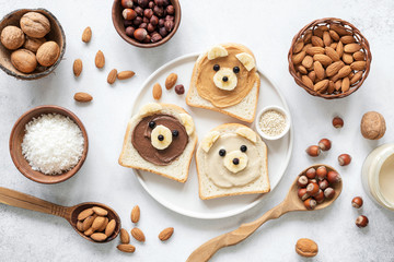 Nut butter banana toast for kids with animal face. Food art, healthy kids meal. Table top view. Healthy eating, healthy lifestyle, kids meal, kids menu, dieting, vegan concept