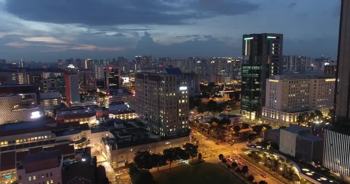 Aerial view of Singapore during cloudy evening / 4k aerial footage of Singapore skyscrapers with city skyline during cloudy evening