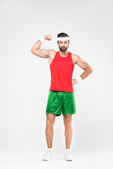 handsome sportsman in retro sportswear showing muscles, isolated on white