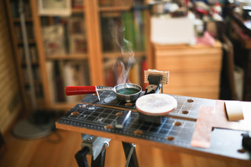 needlewoman puts the wire in boiling water