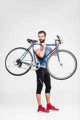 handsome sportsman carrying bicycle, isolated on white