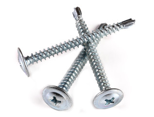 three metal screws isolated on white background closeup