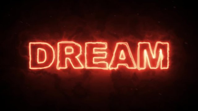 Dream text word from hot burning letters on dark background