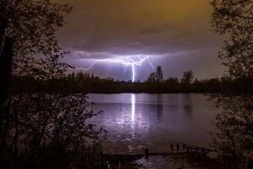 Lightning bolt as summer storm passes over carp fishing lake