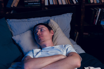 Fototapeta na wymiar Image of brunet with insomnia lying in bed
