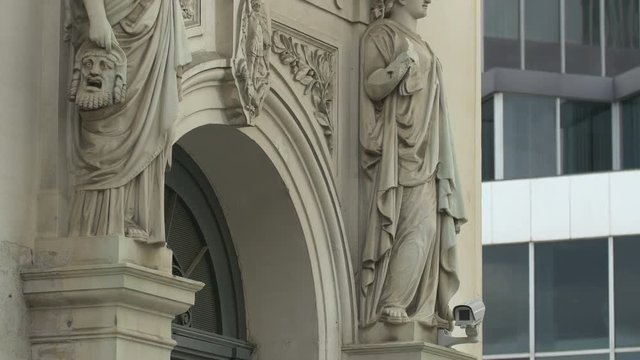 Tilt up of female sculptures on a building